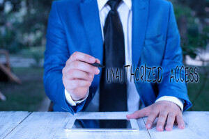Text sign showing Unauthorized Access. Conceptual photo use of a computer or network without permission Businessman holds pen and points into copy space.